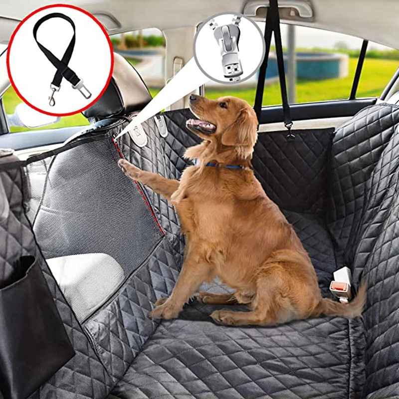 A golden retriever sitting on the black Fourfold Hammock across a car's back seat