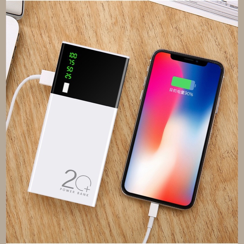 Fourfold Reserve charging a phone through a cable, its display lit