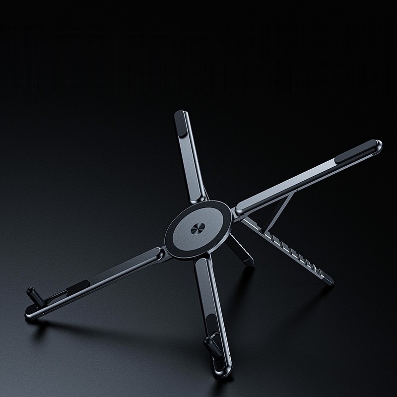 Fourfold Riser Mini aluminum stand opened into its X shape on a dark background, the magnetic disc at its center